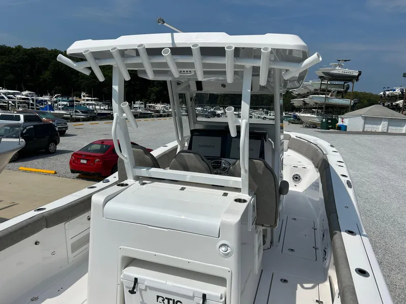 Slide: The Image of 2024 Sea Fox 328 Commander boat at marina, featuring center console and T-top. - 7