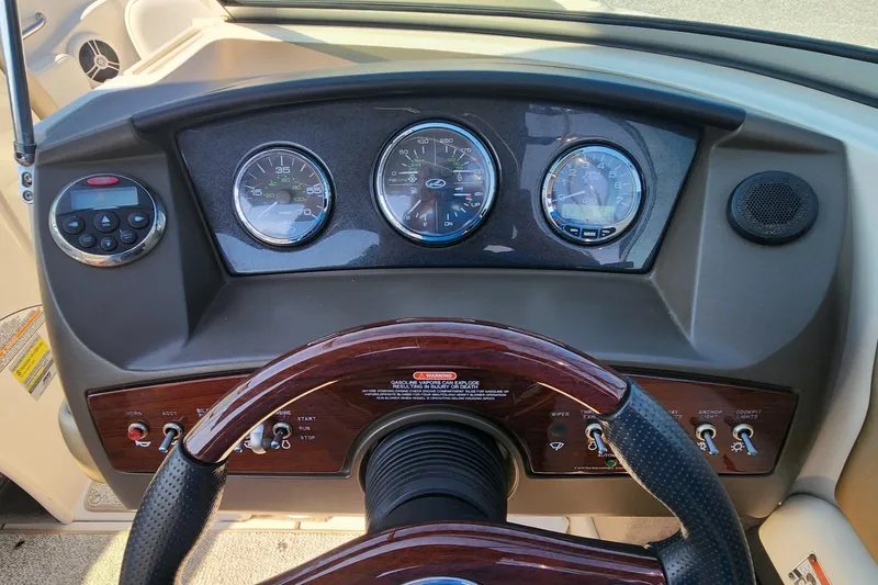 Slide: The Image of Dashboard of a 2007 Sea Ray 210 Select boat with gauges and steering wheel. - 10