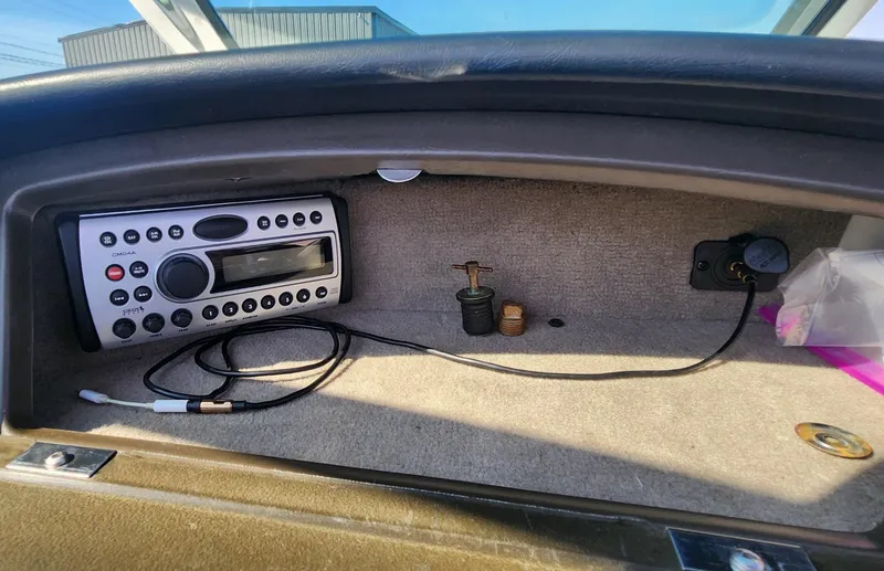 Slide: The Image of 2007 Sea Ray 210 Select dashboard with stereo system and accessory plugs. - 12