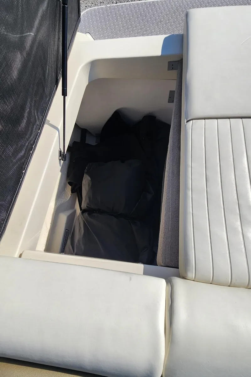 Slide: The Image of 2007 Sea Ray 210 Select boat storage compartment with cushioned seating. - 17