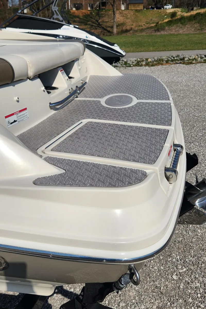 Slide: The Image of 2007 Sea Ray 210 Select boat with textured swim platform and seating area. - 18