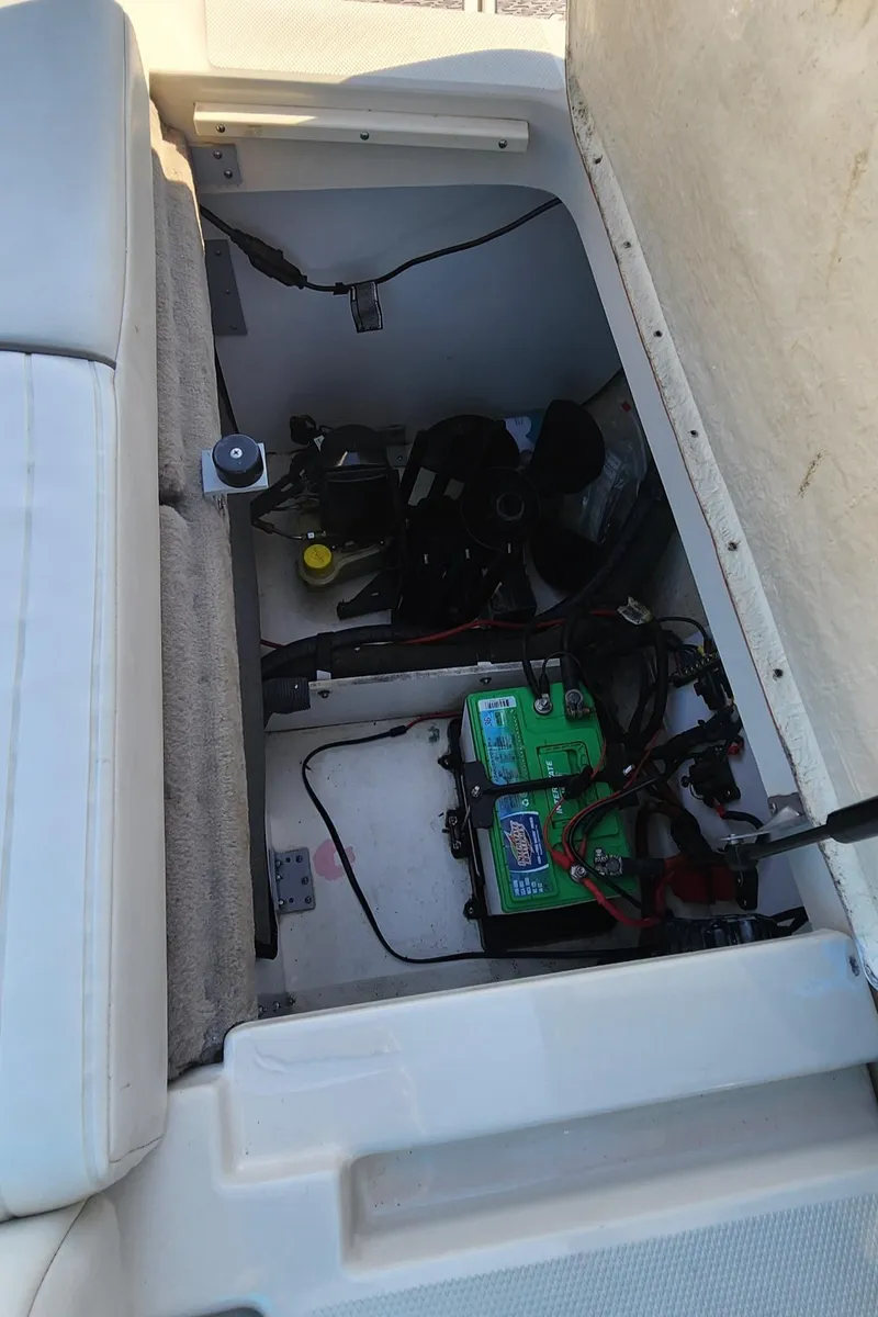 Slide: The Image of 2007 Sea Ray 210 Select boat storage compartment with battery and wiring. - 19
