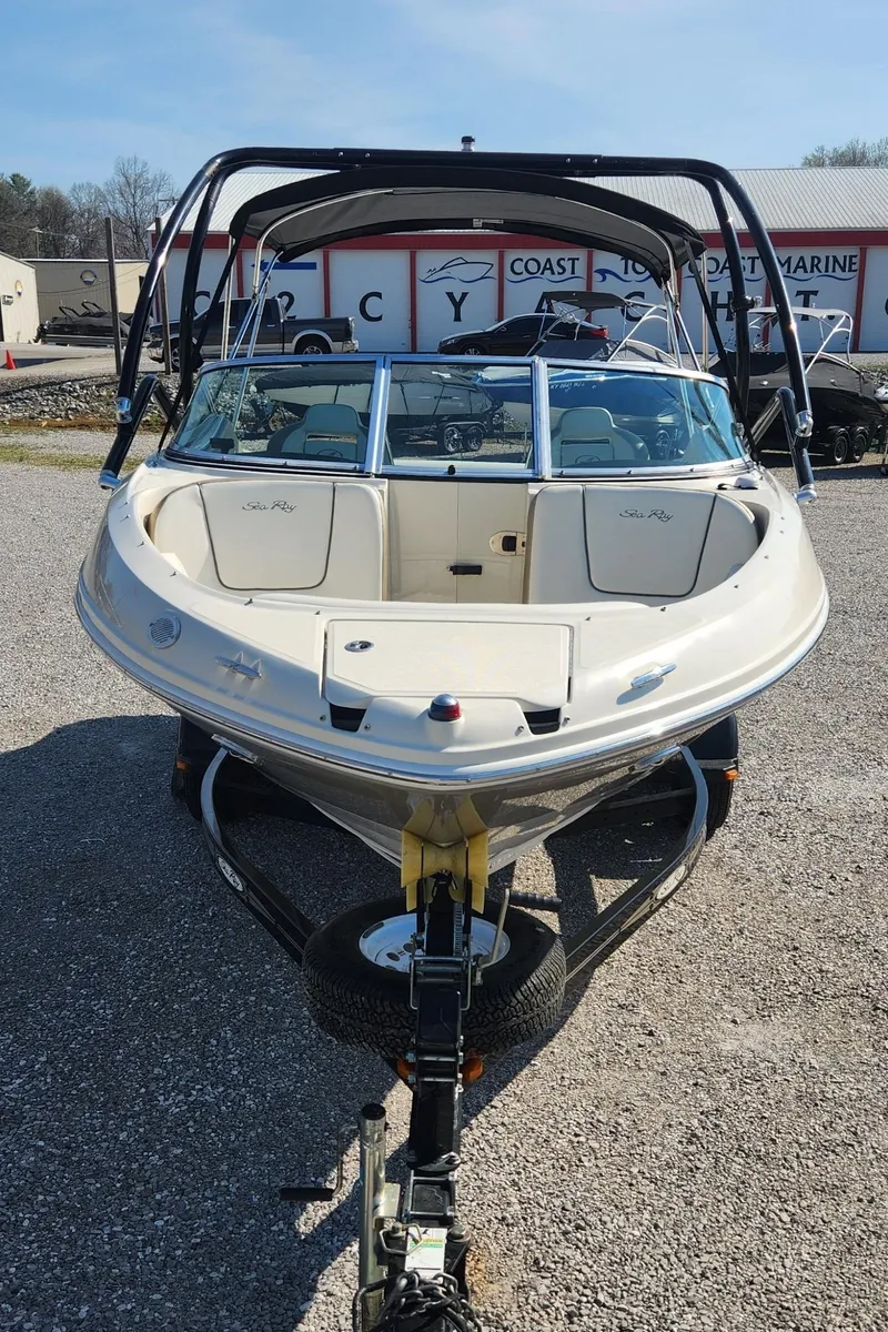 Slide: The Image of 2007 Sea Ray 210 Select boat on trailer, parked outdoors at a marine facility. - 2