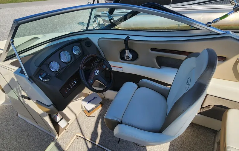 Slide: The Image of 2007 Sea Ray 210 Select boat interior with steering wheel and dashboard controls. - 9