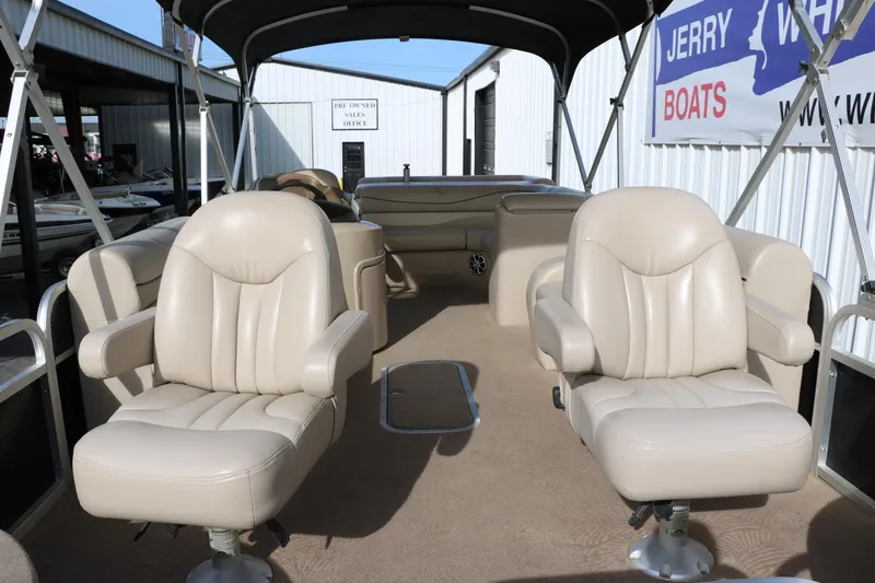 Slide: The Image of 2010 Bennington 2275 GLI pontoon boat interior with beige seating and canopy. - 15