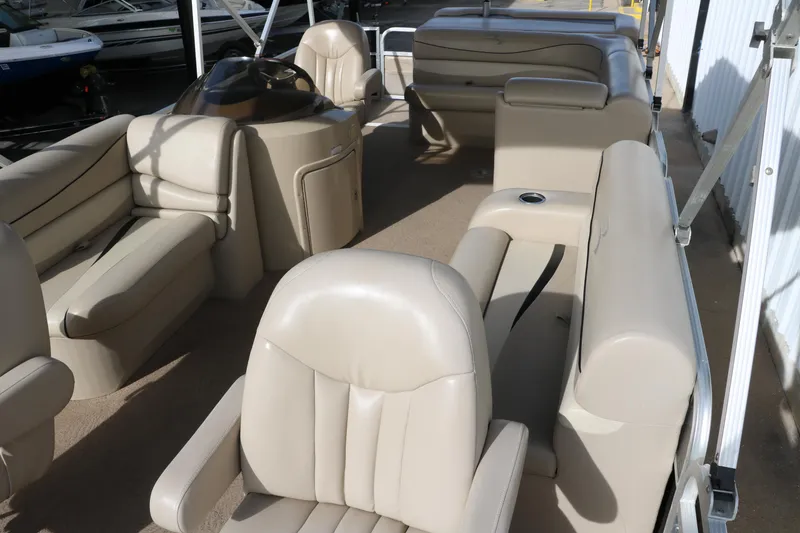 Slide: The Image of 2010 Bennington 2275 GLI pontoon boat interior with beige seating and helm. - 16