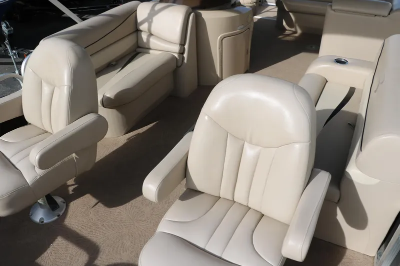 Slide: The Image of 2010 Bennington 2275 GLI boat interior with beige leather seating and spacious layout. - 17