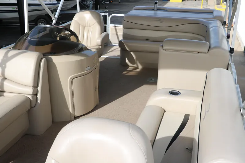 Slide: The Image of 2010 Bennington 2275 GLI pontoon boat interior with beige seating and helm. - 18