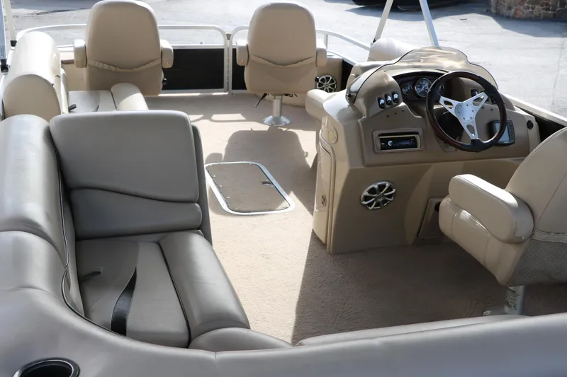 Slide: The Image of Interior of 2010 Bennington 2275 GLI pontoon boat with beige seating and steering console. - 20