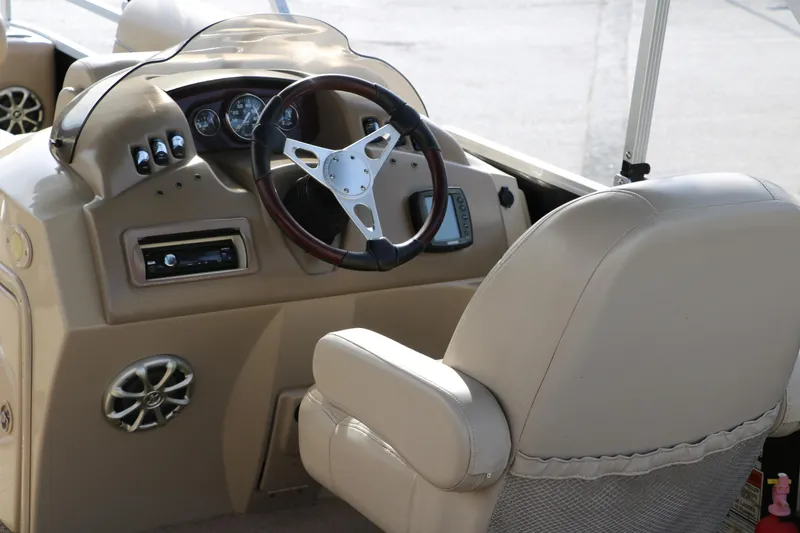 Slide: The Image of 2010 Bennington 2275 GLI boat interior with steering wheel and dashboard controls. - 21