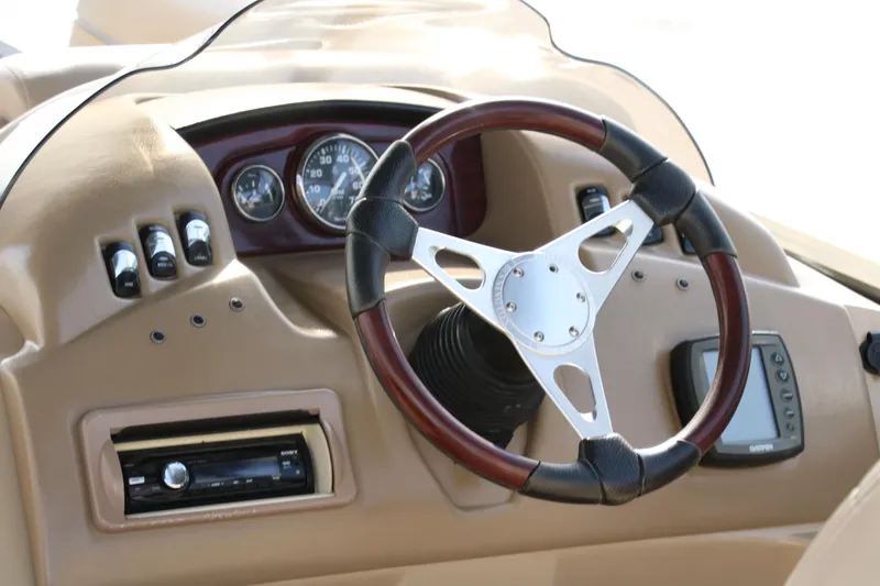 Slide: The Image of Steering wheel and dashboard of 2010 Bennington 2275 GLI boat. - 22