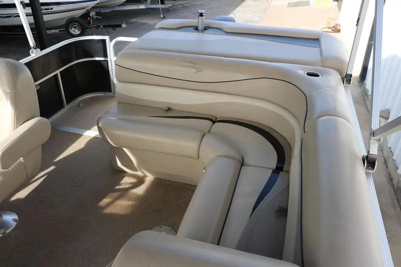 Slide: The Image of 2010 Bennington 2275 GLI pontoon boat interior with beige seating and spacious layout. - 26
