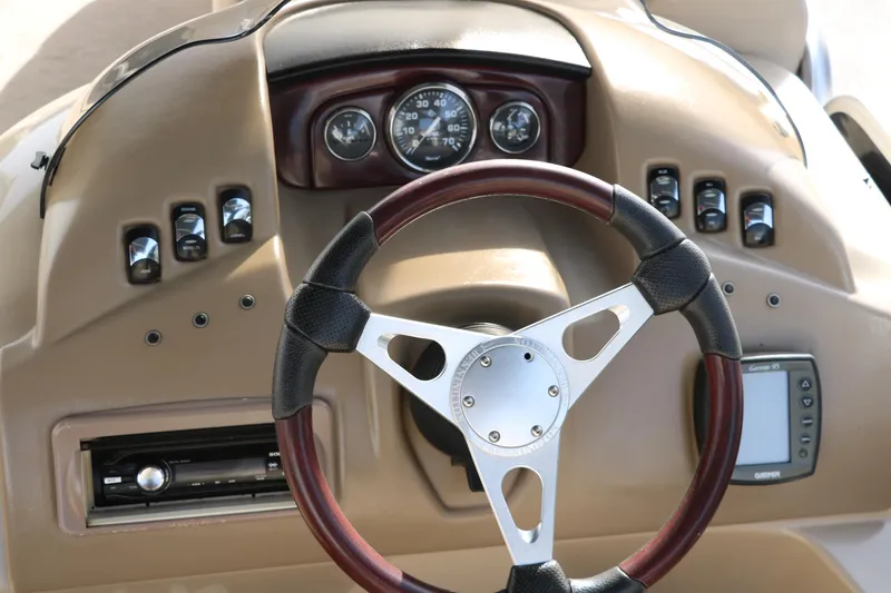 Slide: The Image of Steering console of 2010 Bennington 2275 GLI boat with gauges and controls. - 32