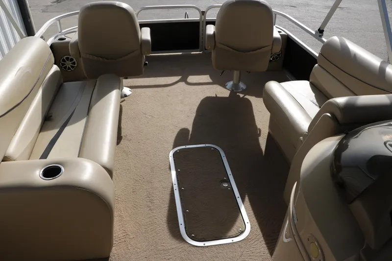 Slide: The Image of 2010 Bennington 2275 GLI pontoon boat interior with beige seating and carpet. - 35