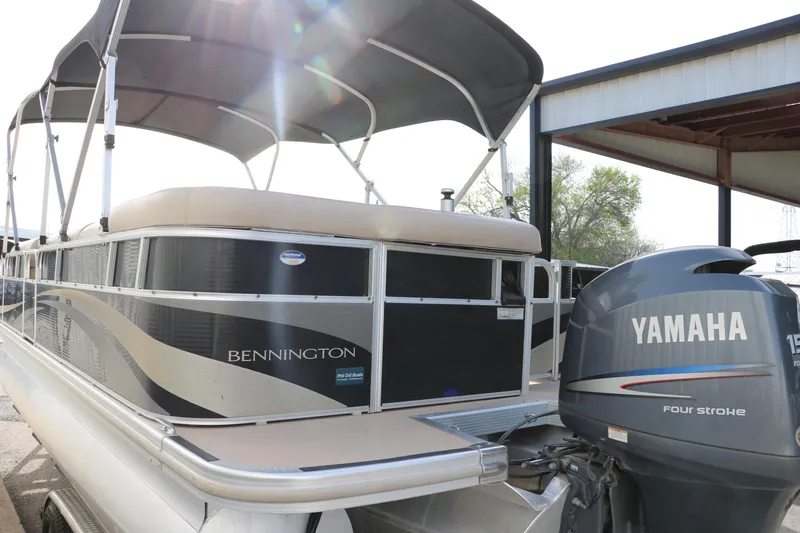 Slide: The Image of 2010 Bennington 2275 GLI pontoon boat with Yamaha four-stroke engine, docked under shelter. - 6