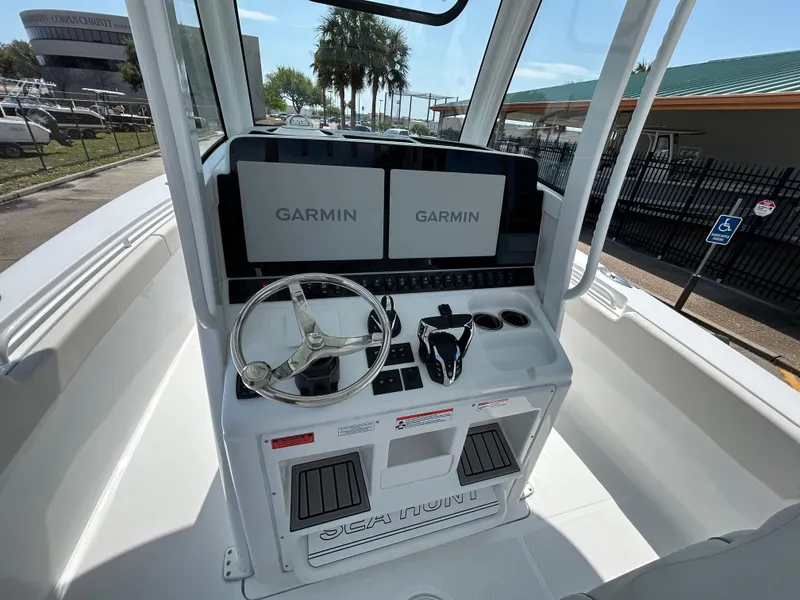 Slide: The Image of 2025 Sea Hunt Gamefish 28 helm with dual Garmin displays and steering wheel. - 13