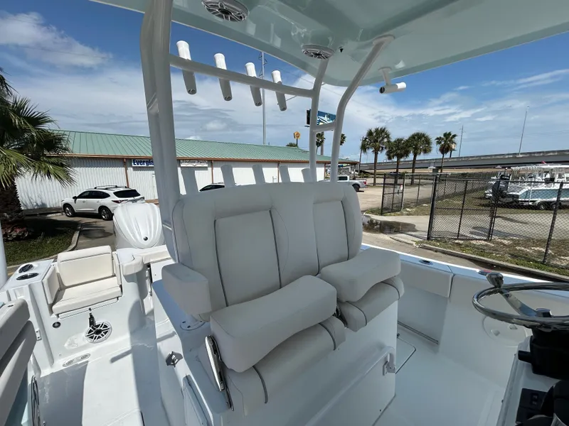 Slide: The Image of 2025 Sea Hunt Gamefish 28 boat interior with cushioned seating and rod holders. - 17
