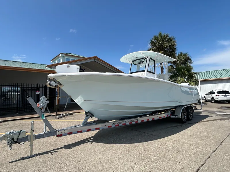 Slide: The Image of 2025 Sea Hunt Gamefish 28 with Coffin Box on trailer, parked outdoors. - 2