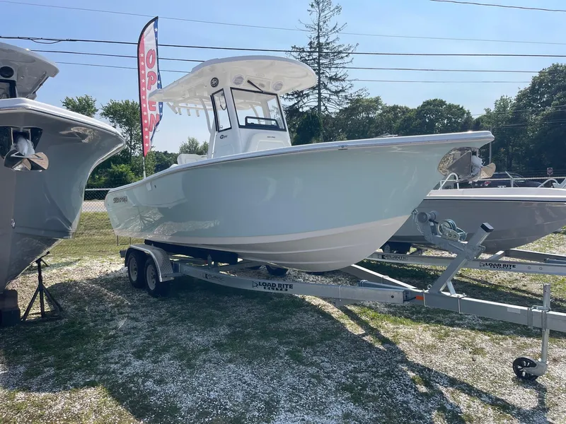 Slide: The Image of 2025 Sea Pro 242 Center Console boat on trailer, displayed outdoors. - 1