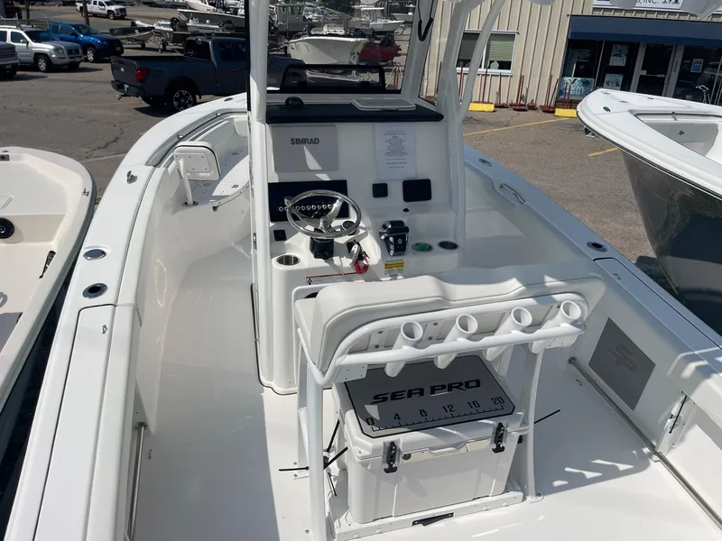 Slide: The Image of 2025 Sea Pro 242 Center Console boat interior with steering wheel and seating. - 14