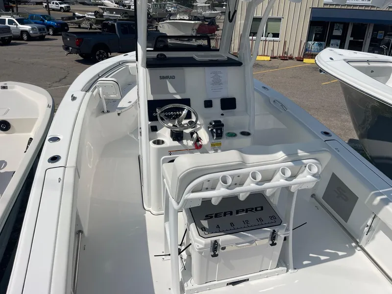 Slide: The Image of 2025 Sea Pro 242 Center Console boat interior with steering and seating area. - 15