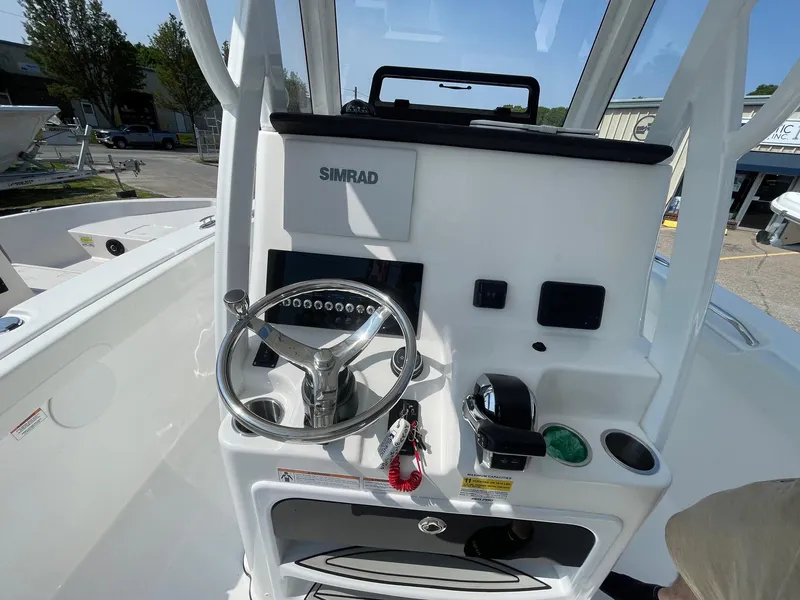Slide: The Image of 2025 Sea Pro 242 Center Console boat helm with Simrad electronics and steering wheel. - 17
