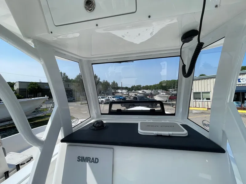 Slide: The Image of 2025 Sea Pro 242 Center Console boat interior with Simrad navigation system. - 18