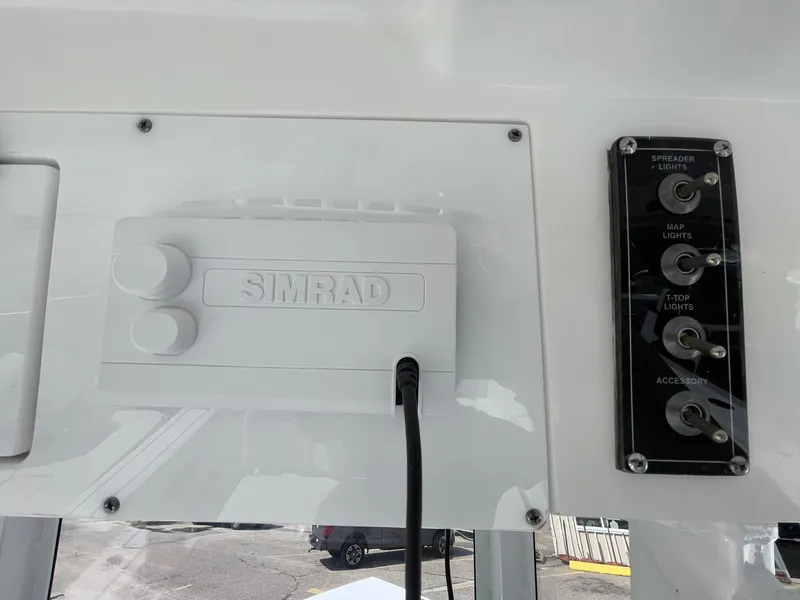 Slide: The Image of 2025 Sea Pro 242 Center Console dashboard with Simrad system and control panel. - 21