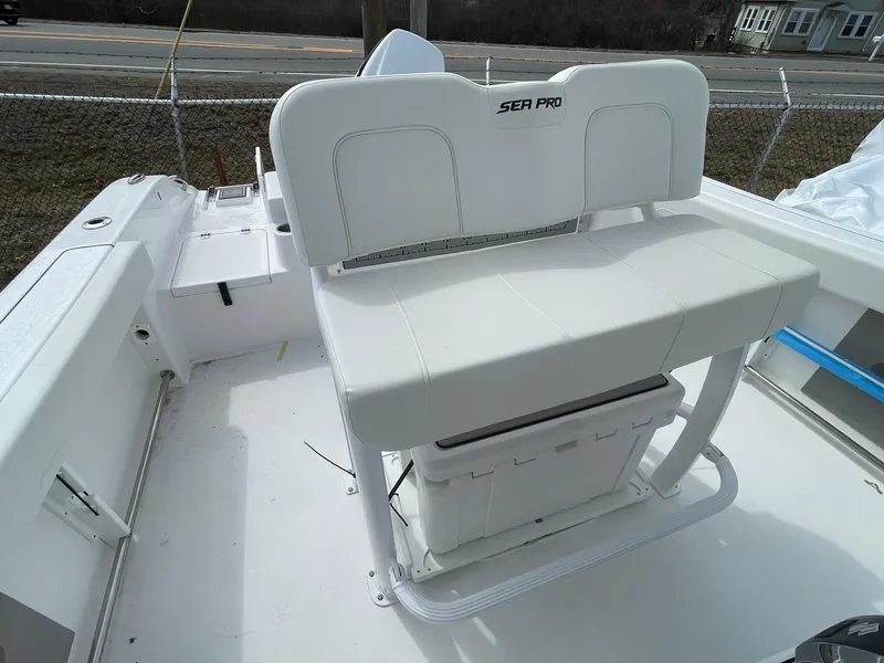 Slide: The Image of 2025 Sea Pro 242 Center Console boat interior with white seating and storage. - 22