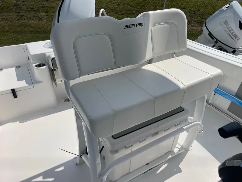 Slide: The Image of 2025 Sea Pro 242 Center Console boat seat with white upholstery and storage underneath. - 23