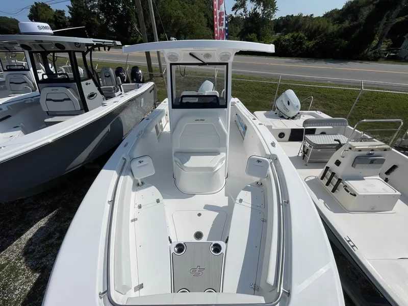 Slide: The Image of 2025 Sea Pro 242 Center Console boat, white exterior, docked outdoors. - 25