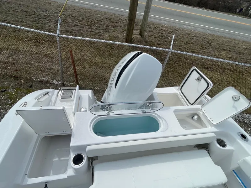 Slide: The Image of 2025 Sea Pro 242 Center Console boat with open compartments and engine, viewed from above. - 28