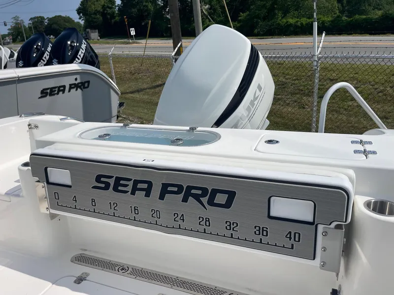 Slide: The Image of 2025 Sea Pro 242 Center Console boat with measuring board and outboard motor. - 29
