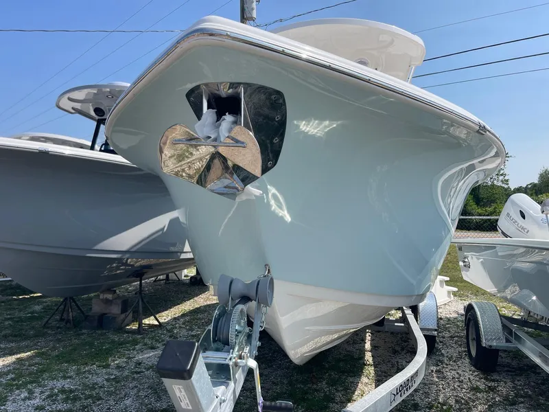 Slide: The Image of 2025 Sea Pro 242 Center Console boat on trailer, front view, outdoors. - 3