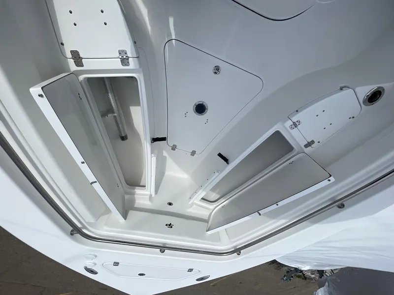 Slide: The Image of 2025 Sea Pro 242 Center Console boat storage compartments, white interior view. - 32