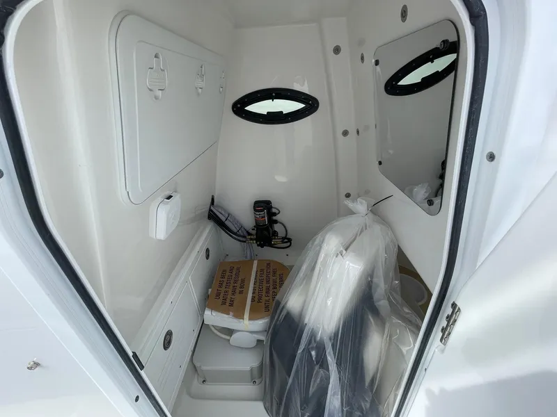 Slide: The Image of Interior of 2025 Sea Pro 242 Center Console boat, featuring storage and seating area. - 34