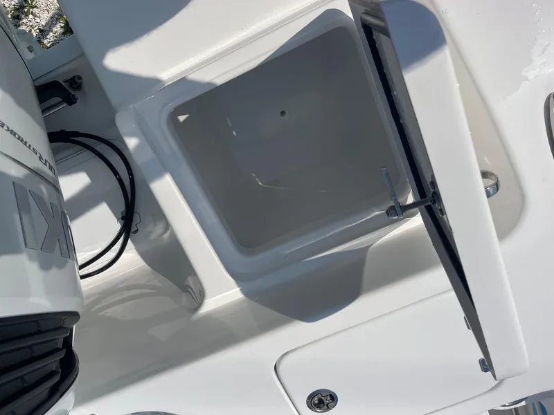 Slide: The Image of 2025 Sea Pro 242 Center Console boat storage compartment, open lid view. - 38