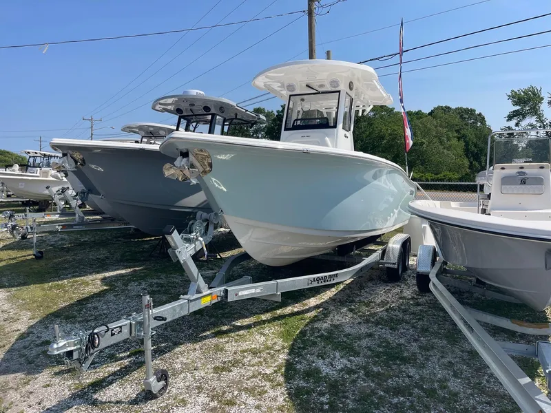 Slide: The Image of 2025 Sea Pro 242 Center Console boat on trailer, displayed outdoors. - 4