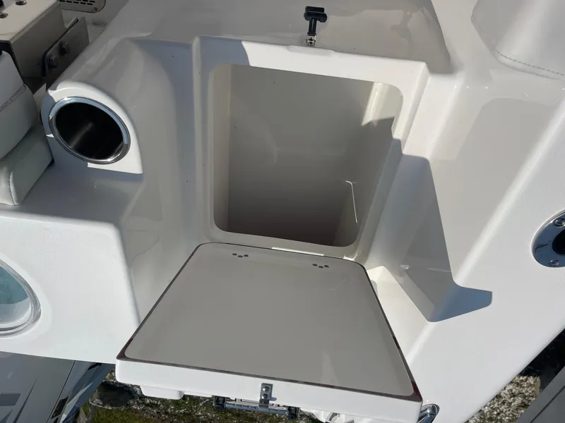 Slide: The Image of 2025 Sea Pro 242 Center Console storage compartment with open hatch, showcasing interior space. - 41