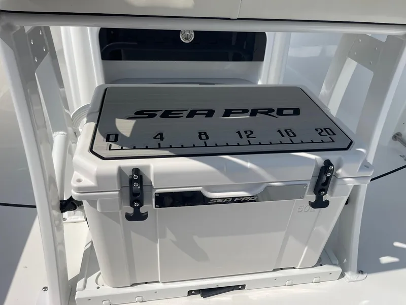 Slide: The Image of 2025 Sea Pro 242 Center Console cooler with measuring scale on lid. - 42
