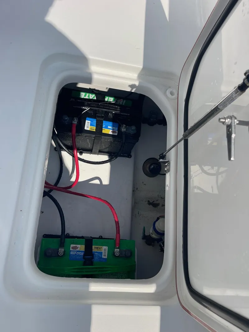 Slide: The Image of 2025 Sea Pro 242 Center Console boat battery compartment with wiring and components. - 47