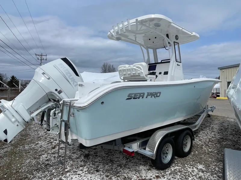 Slide: The Image of 2025 Sea Pro 242 Center Console boat on trailer, featuring sleek design and powerful engine. - 8