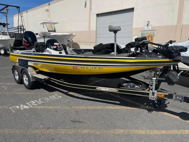 Slide: The Image of 2006 Skeeter 20i boat on trailer, parked outdoors, yellow and black design. - 1