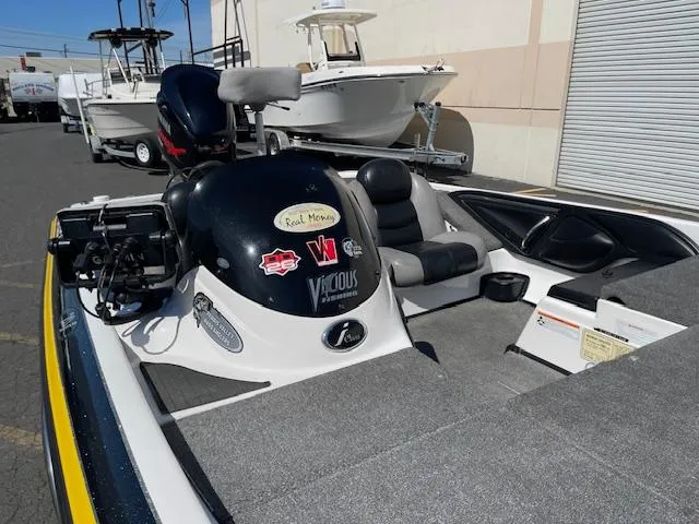 Slide: The Image of 2006 Skeeter 20i boat with motor, parked outdoors near other boats. - 11