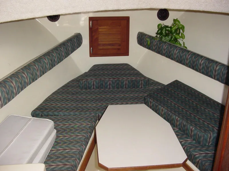Slide: The Image of 1996 Albemarle 275 Express cabin interior with patterned seating and a small table. - 20