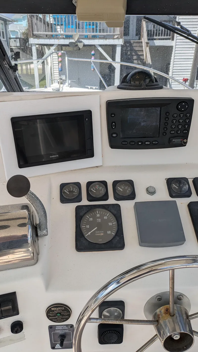 Slide: The Image of 1996 Albemarle 275 Express boat dashboard with navigation instruments and steering wheel. - 7