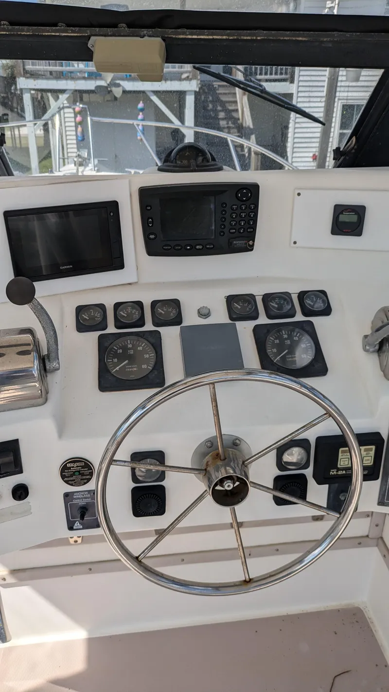 Slide: The Image of 1996 Albemarle 275 Express boat dashboard with steering wheel and navigation instruments. - 8