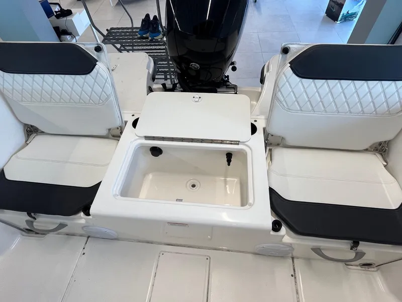 Slide: The Image of 2022 Bayliner Trophy T22CC boat interior with seating and storage compartment. - 10