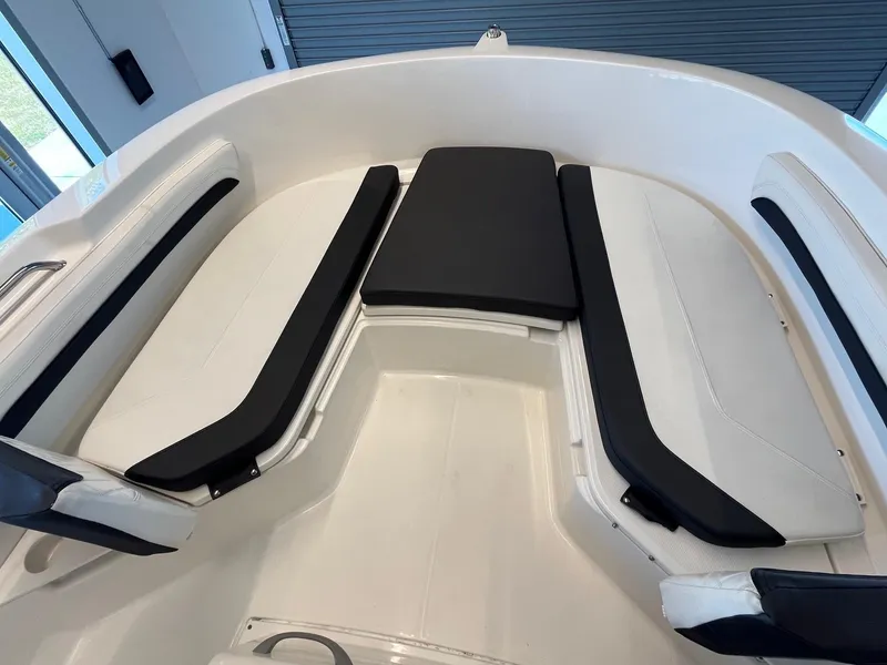 Slide: The Image of 2022 Bayliner Trophy T22CC boat interior with cushioned seating in a sleek, modern design. - 7