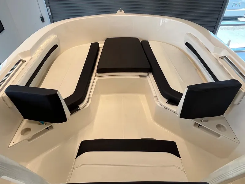 Slide: The Image of 2022 Bayliner Trophy T22CC boat interior with cushioned seating and sleek design. - 8
